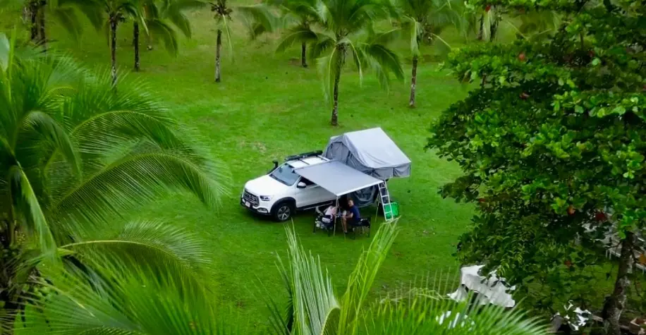 jac t8 white vehicle camping in jungle